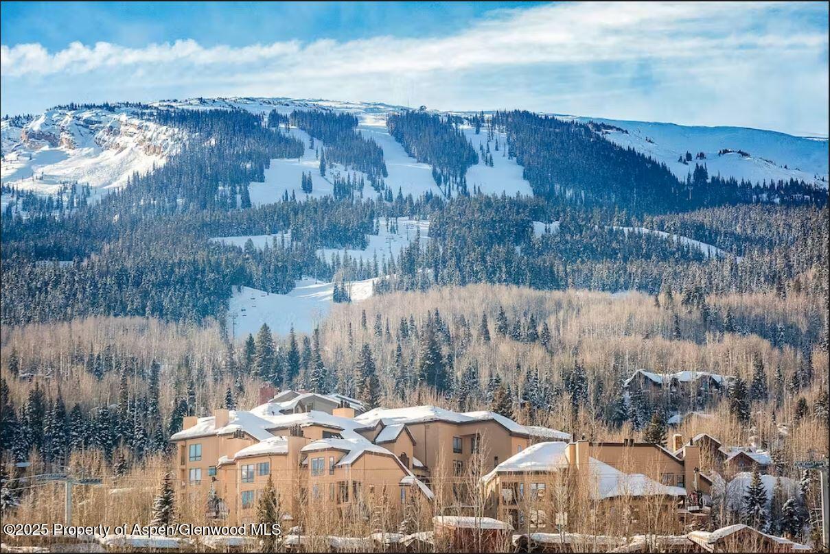 476 Wood Road, Unit 41 Snowmass Village, CO 81615 - Photo 1 of 29 a view of a lake with mountains in the background