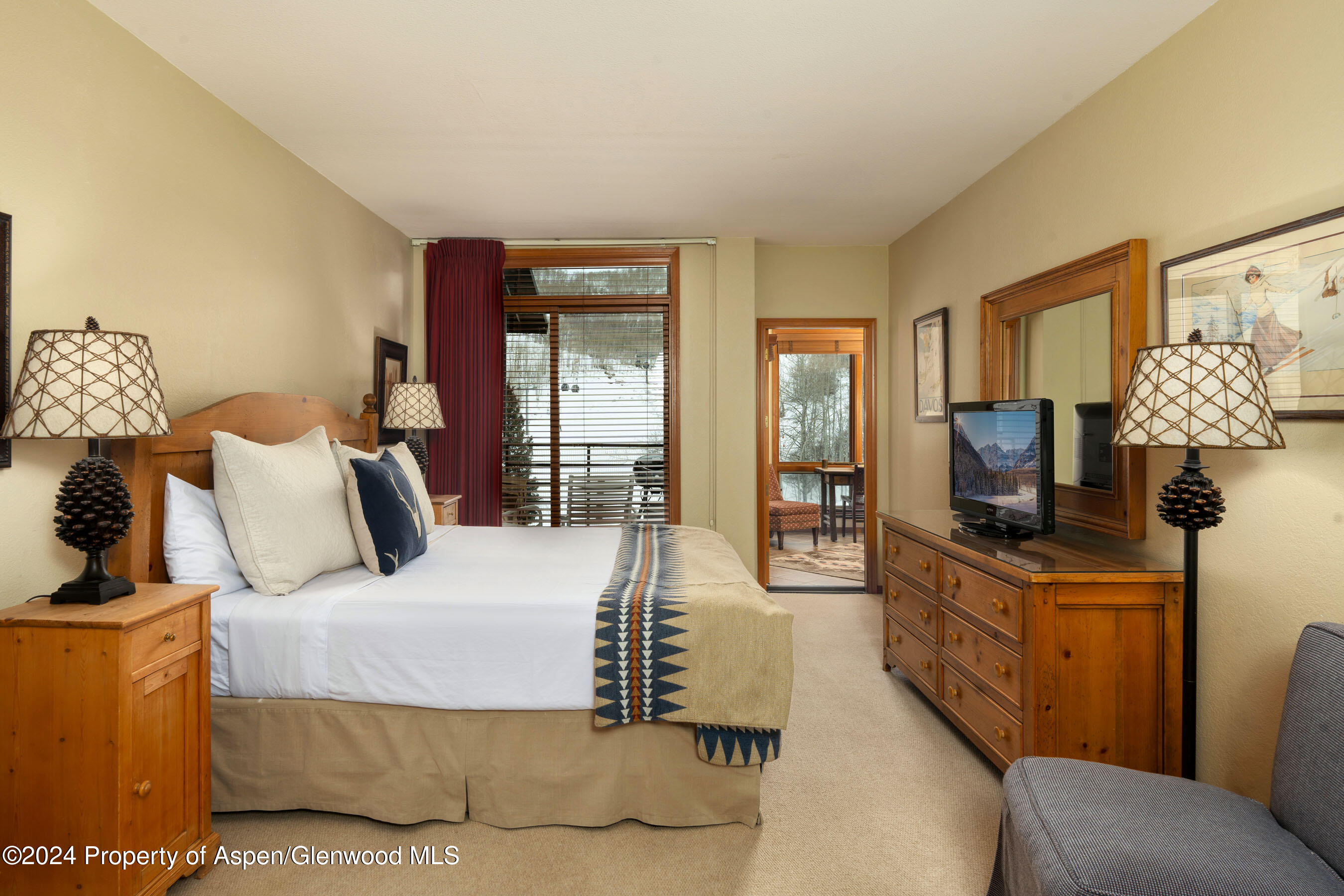 476 Wood Road, Unit 41 Snowmass Village, CO 81615 - Photo 9 of 29 a bedroom with a bed and wooden floor