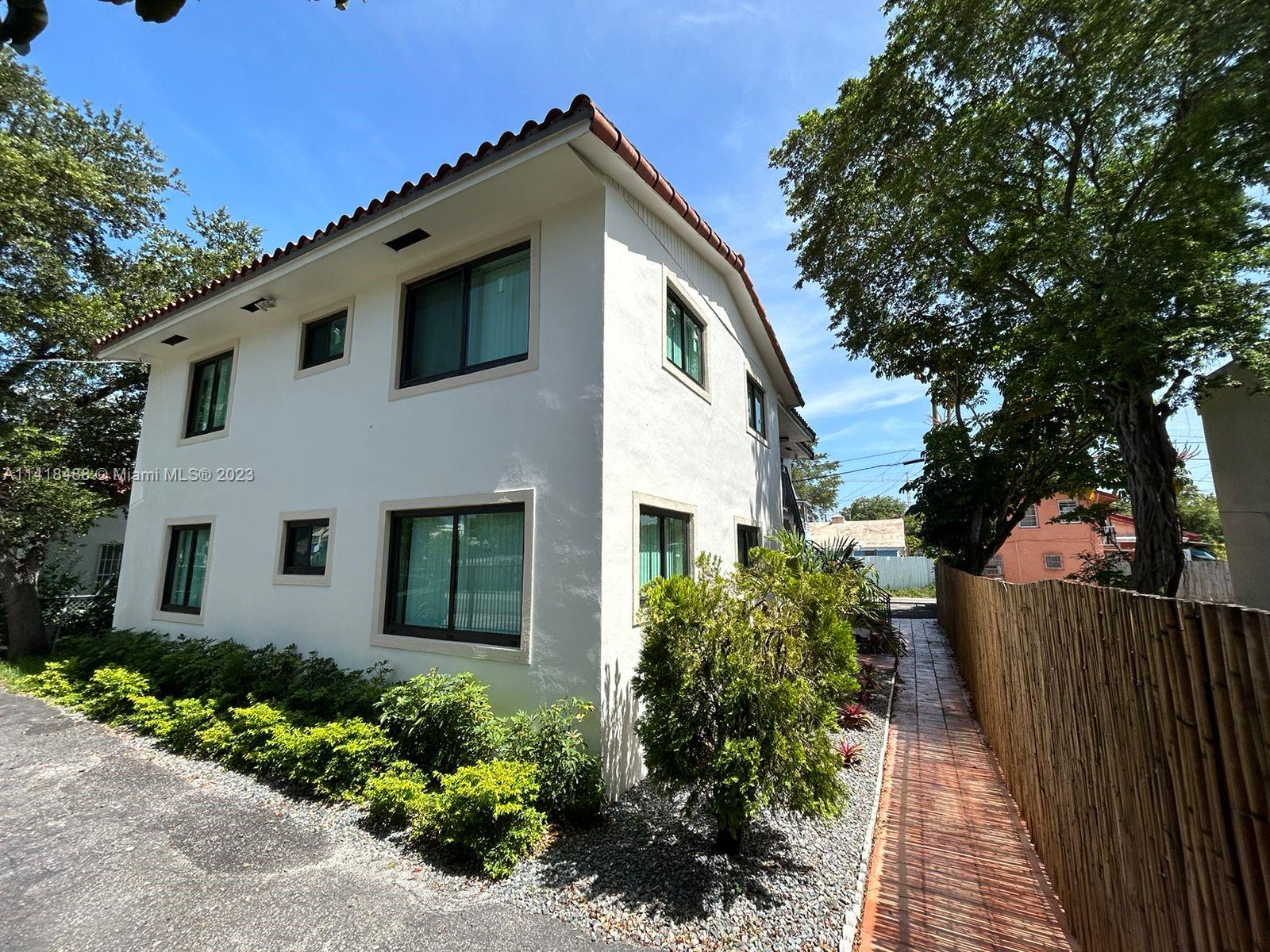 a front view of a house with garden