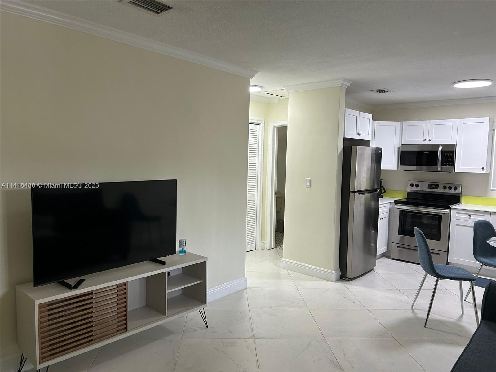 46 Northwest 35th Street Miami, FL 33127 - Photo 5 of 17 a view of kitchen with refrigerator stove and microwave