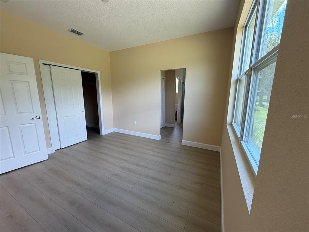 4661 Hickory Tree Road St. Cloud, FL 34772 - Photo 18 of 20 a view of an empty room with wooden floor and a window