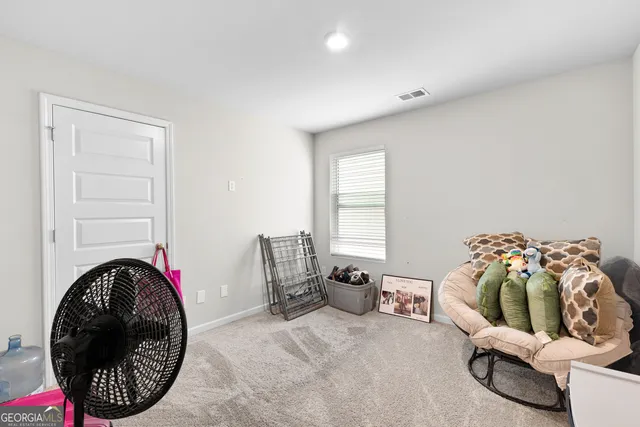 a bed room with a bed and a chair