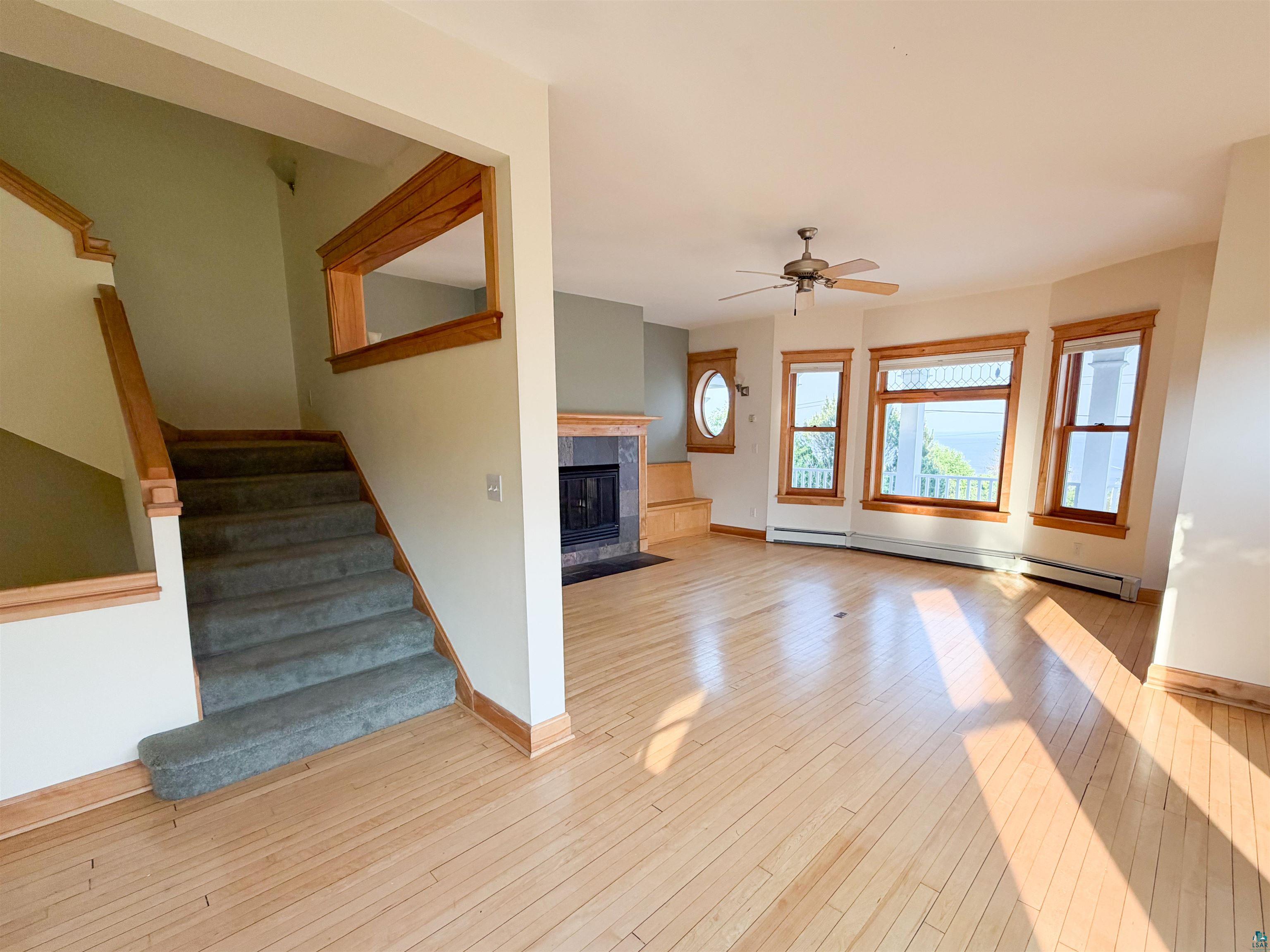 13 West 8th Street Duluth, MN 55806 - Photo 5 of 57 Light wood-finish flooring extending throughout, complemented by a staircase featuring carpeted treads and wood railings