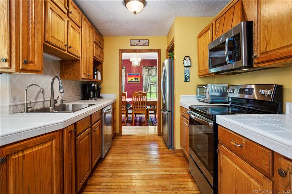 37 Hidden Hill Road New Hartford, CT 06057 - Photo 11 of 36 a kitchen with stainless steel appliances granite countertop a sink and a stove