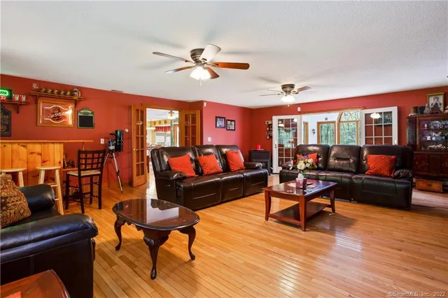 a living room with furniture a rug and a window
