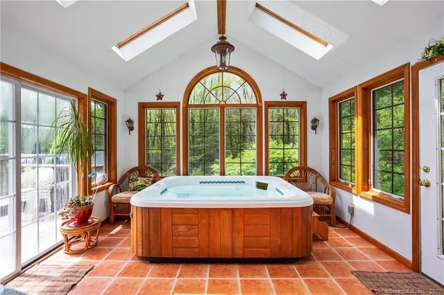 a bed sitting in a room next to a large window