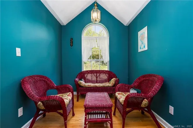 a view of a room with furniture and wooden floor