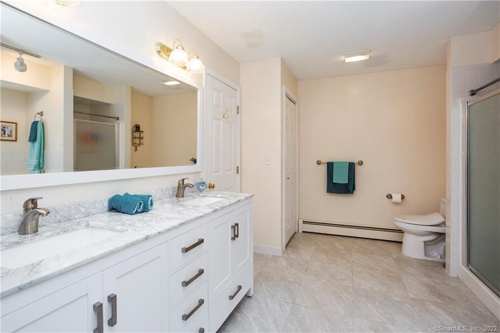 37 Hidden Hill Road New Hartford, CT 06057 - Photo 21 of 36 a bathroom with a double vanity sink toilet and mirror