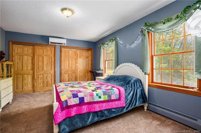 a bedroom with a bed and window