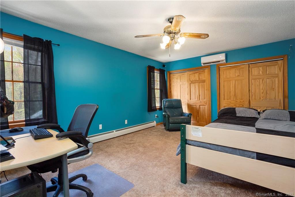 37 Hidden Hill Road New Hartford, CT 06057 - Photo 26 of 36 a living room with furniture a large window and a chandelier