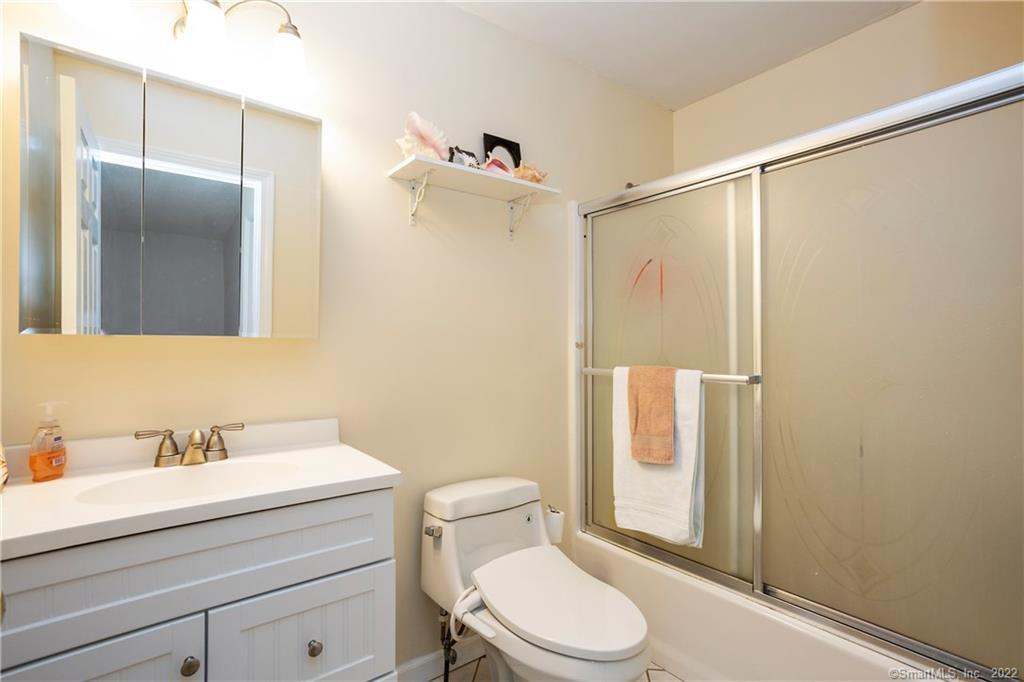 37 Hidden Hill Road New Hartford, CT 06057 - Photo 28 of 36 a bathroom with a sink a mirror a toilet and shower