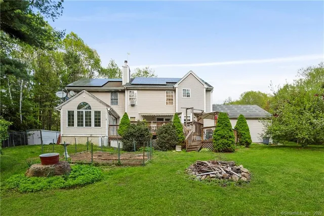 a front view of house with yard and green space