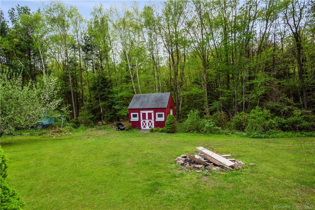 37 Hidden Hill Road New Hartford, CT 06057 - Photo 30 of 36 a backyard of a house with lots of green space and garden