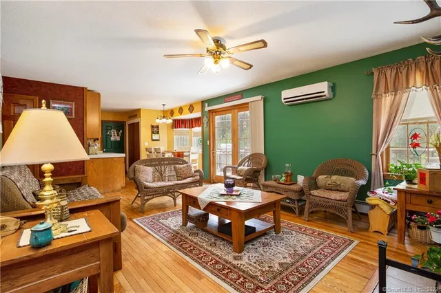 a living room with furniture fireplace and a large window