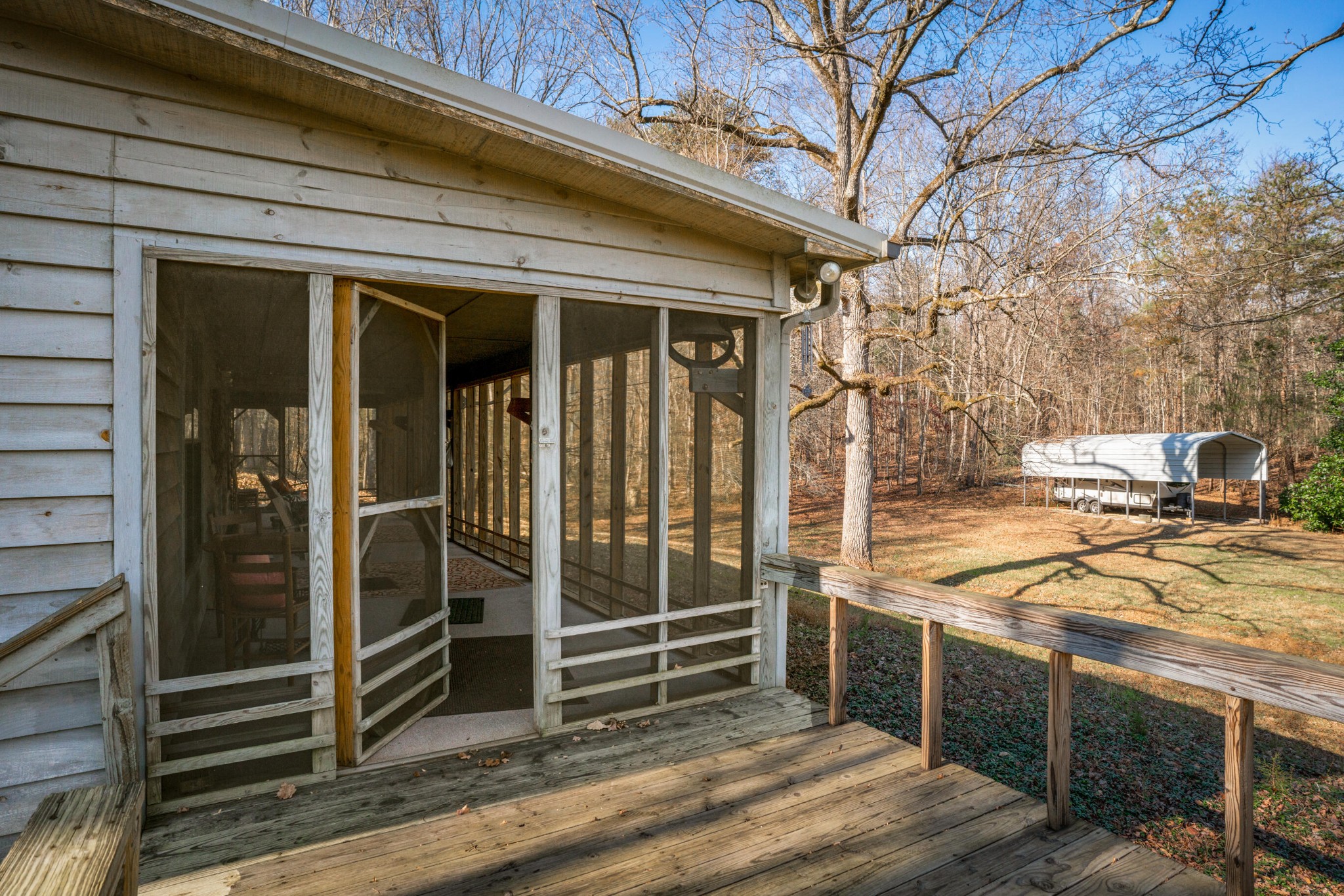 11405 Highway 58 Georgetown, TN 37336 - Photo 21 of 70 a view of a patio with table and chairs and wooden floor