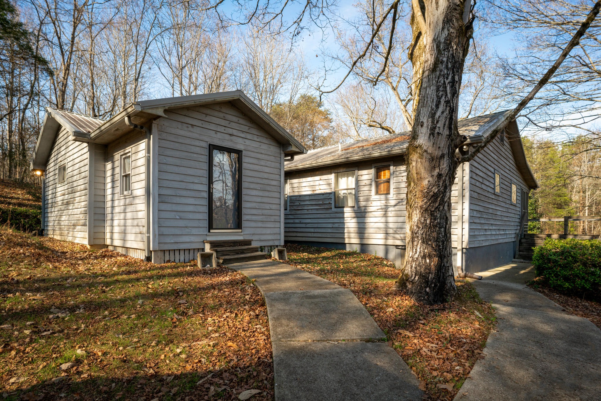 11405 Highway 58 Georgetown, TN 37336 - Photo 22 of 70 a backyard of a house with large trees and outdoor seating