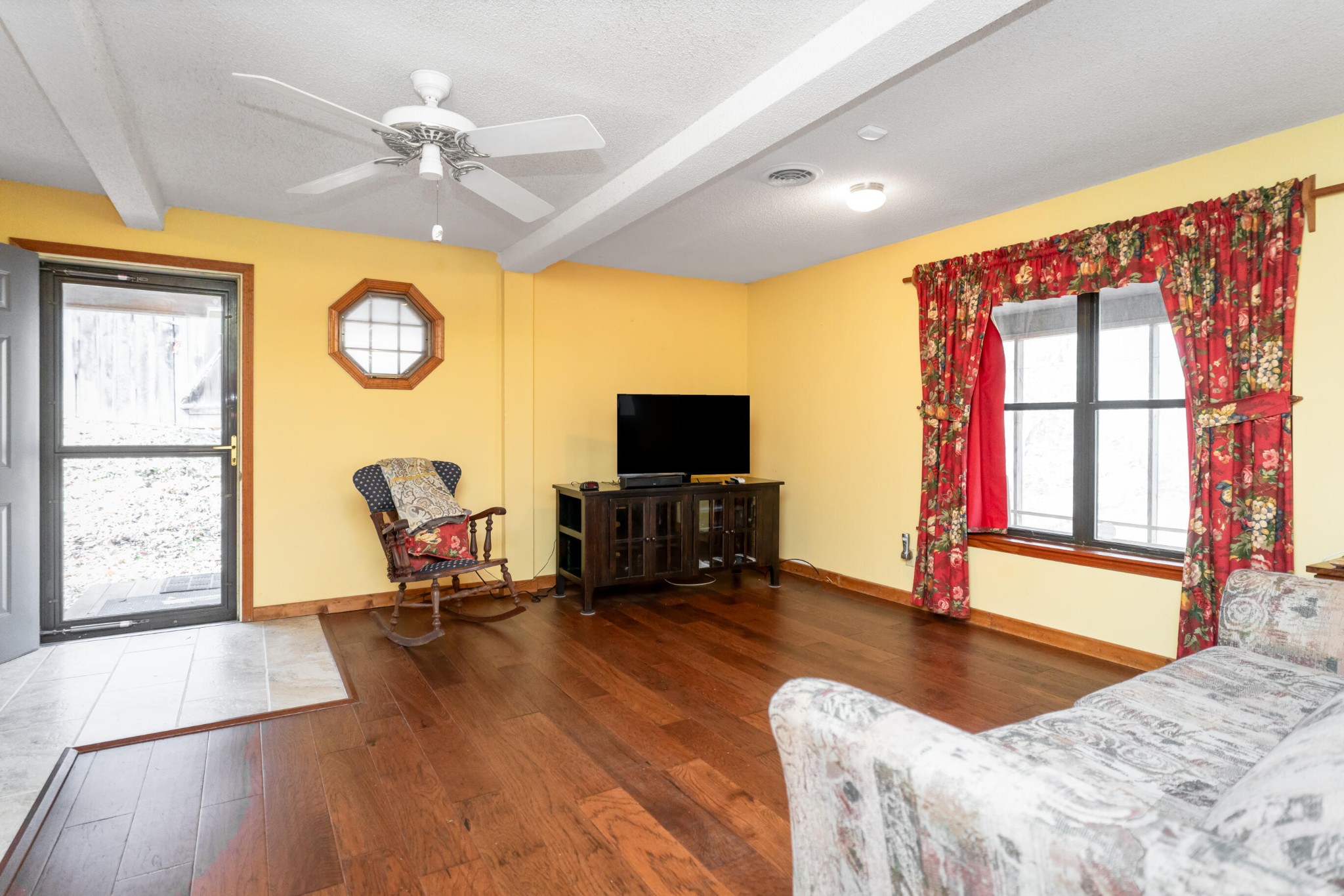 11405 Highway 58 Georgetown, TN 37336 - Photo 38 of 70 a living room with furniture a flat screen tv and a large window