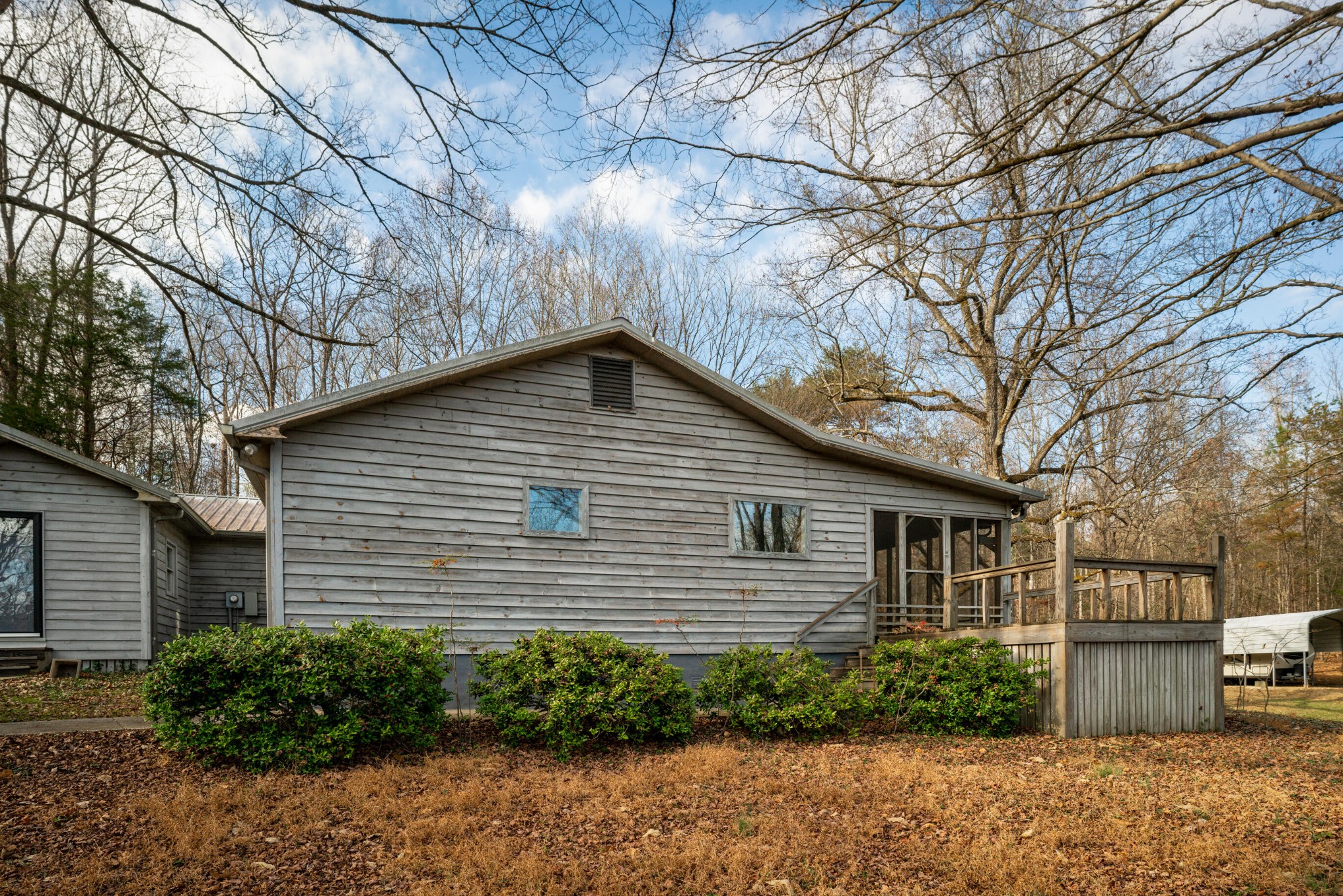 11405 Highway 58 Georgetown, TN 37336 - Photo 6 of 70 a small white house with a small yard and a large tree