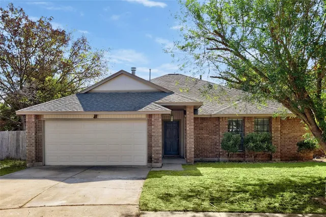 a front view of a house with a garden and yard