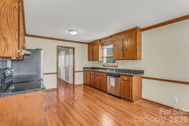 a kitchen with a refrigerator and a stove top oven