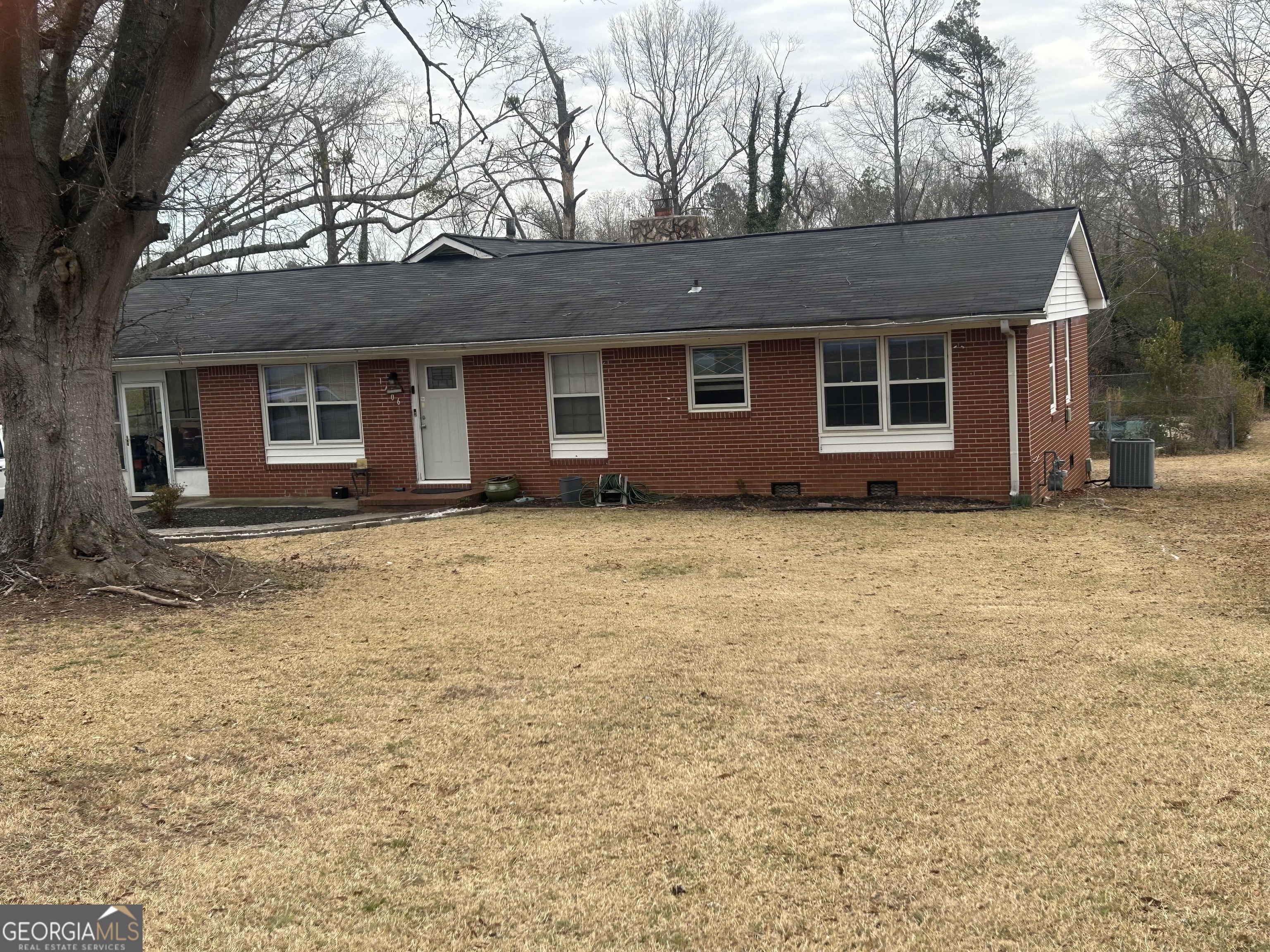 1406 Canterbury Road Griffin, GA 30223 - Photo 2 of 26 a house that has a tree in front of it