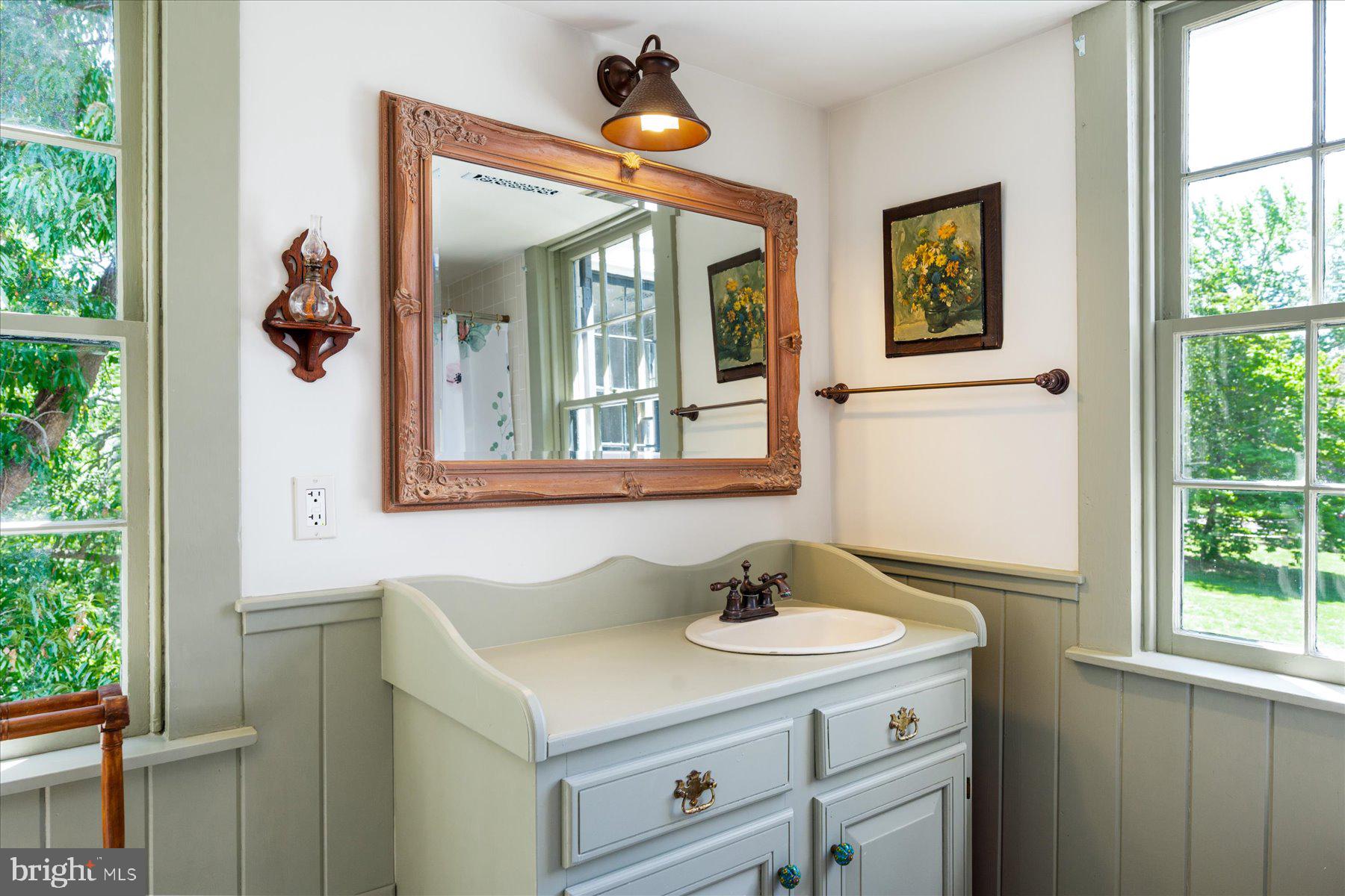 5503 Brooks Woods Road Lothian, MD 20711 - Photo 37 of 99 a bathroom with a sink and a mirror