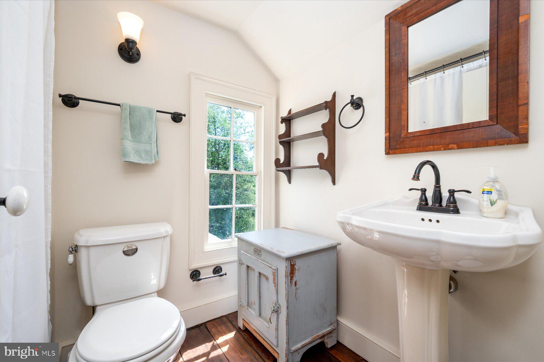 5503 Brooks Woods Road Lothian, MD 20711 - Photo 42 of 99 a bathroom with a toilet sink and mirror