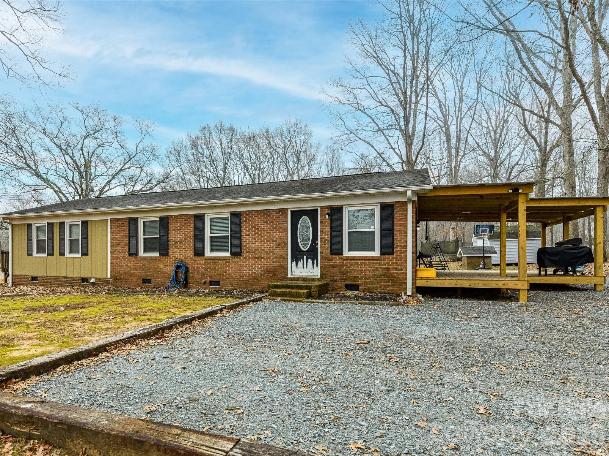 2303 Long Hope Road Monroe, NC 28112 - Photo 1 of 33 a view of a house with backyard sitting area and garden
