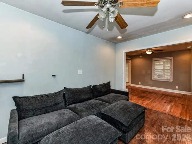 a living room with furniture and a chandelier
