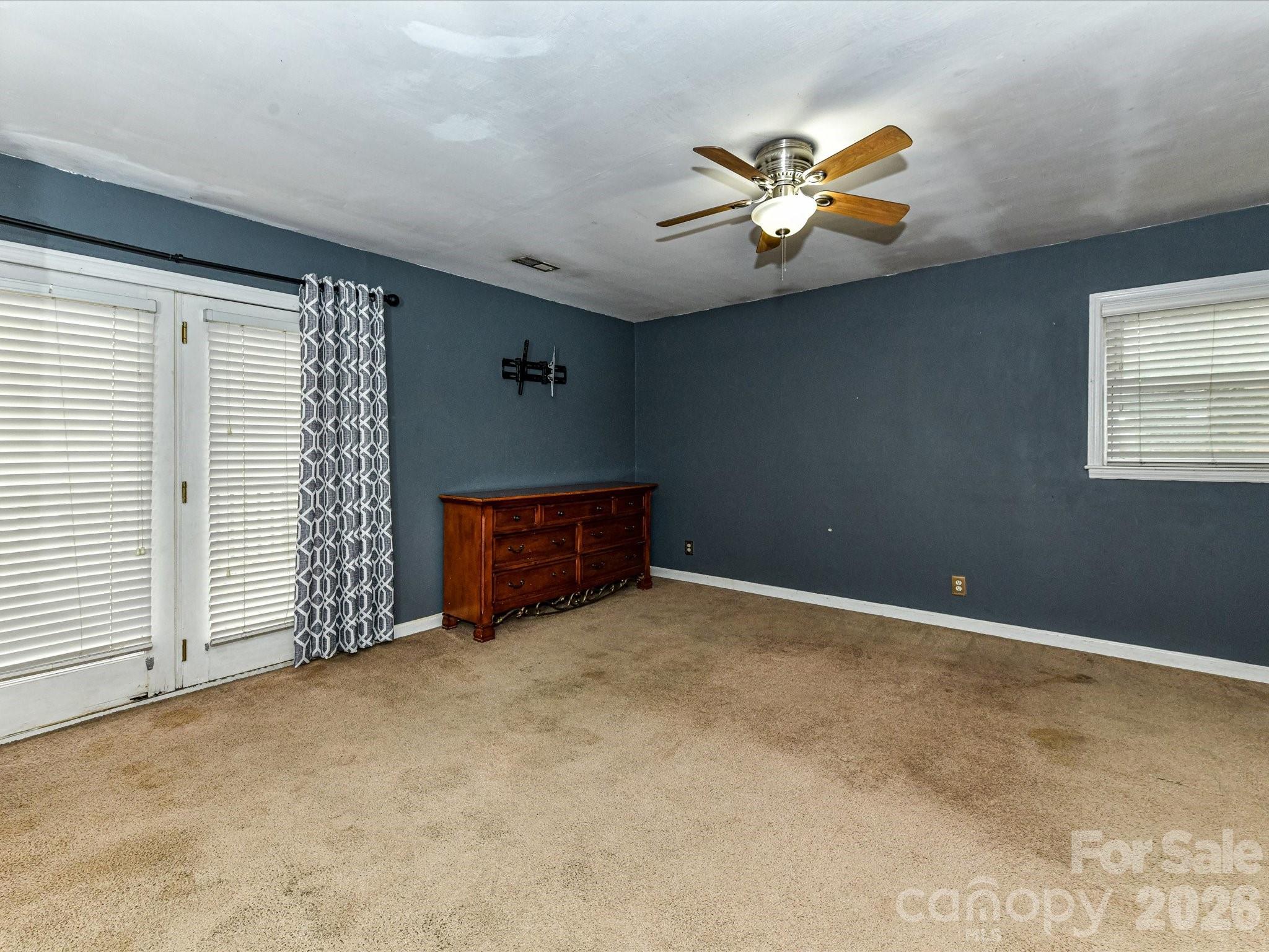 2303 Long Hope Road Monroe, NC 28112 - Photo 22 of 33 an empty room with windows and ceiling fan