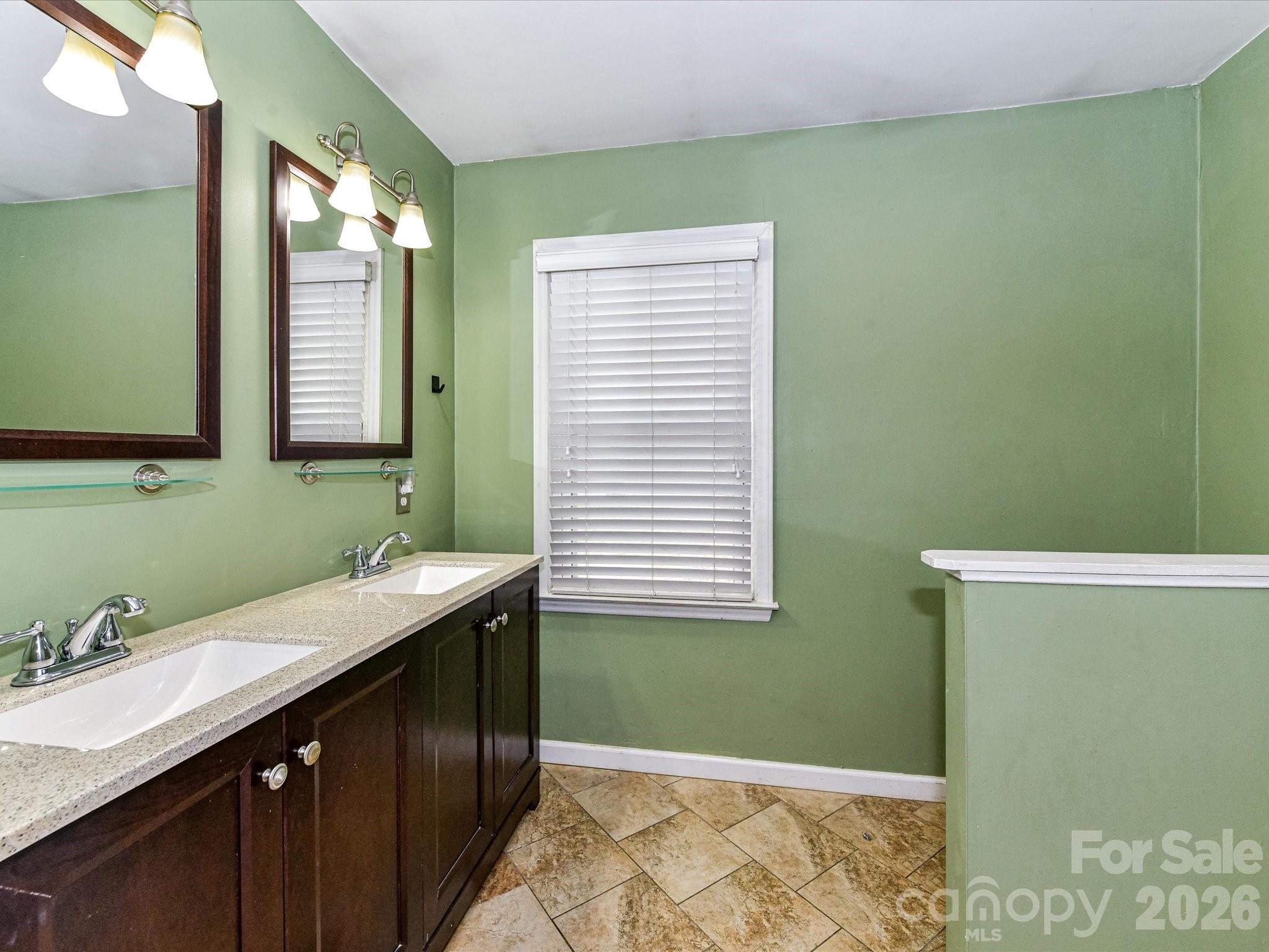 2303 Long Hope Road Monroe, NC 28112 - Photo 26 of 33 a bathroom with a sink and a mirror