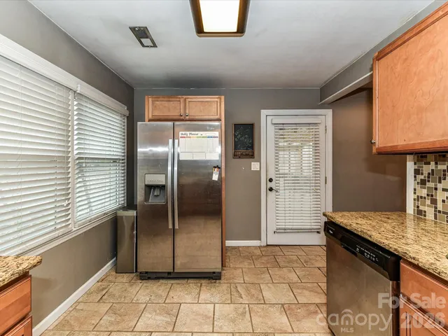 a kitchen with a refrigerator a oven and cabinets