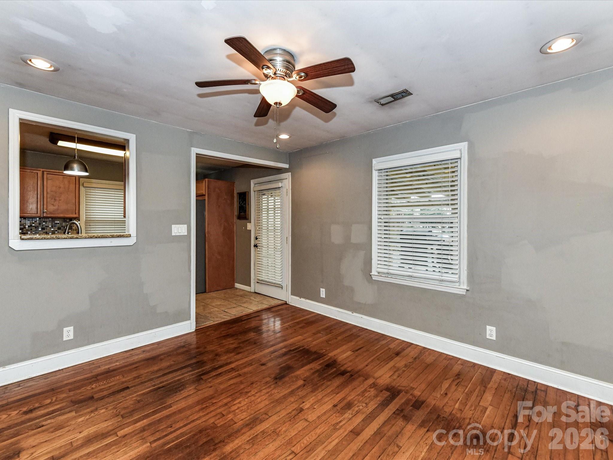 2303 Long Hope Road Monroe, NC 28112 - Photo 10 of 33 a view of an empty room with wooden floor and a window