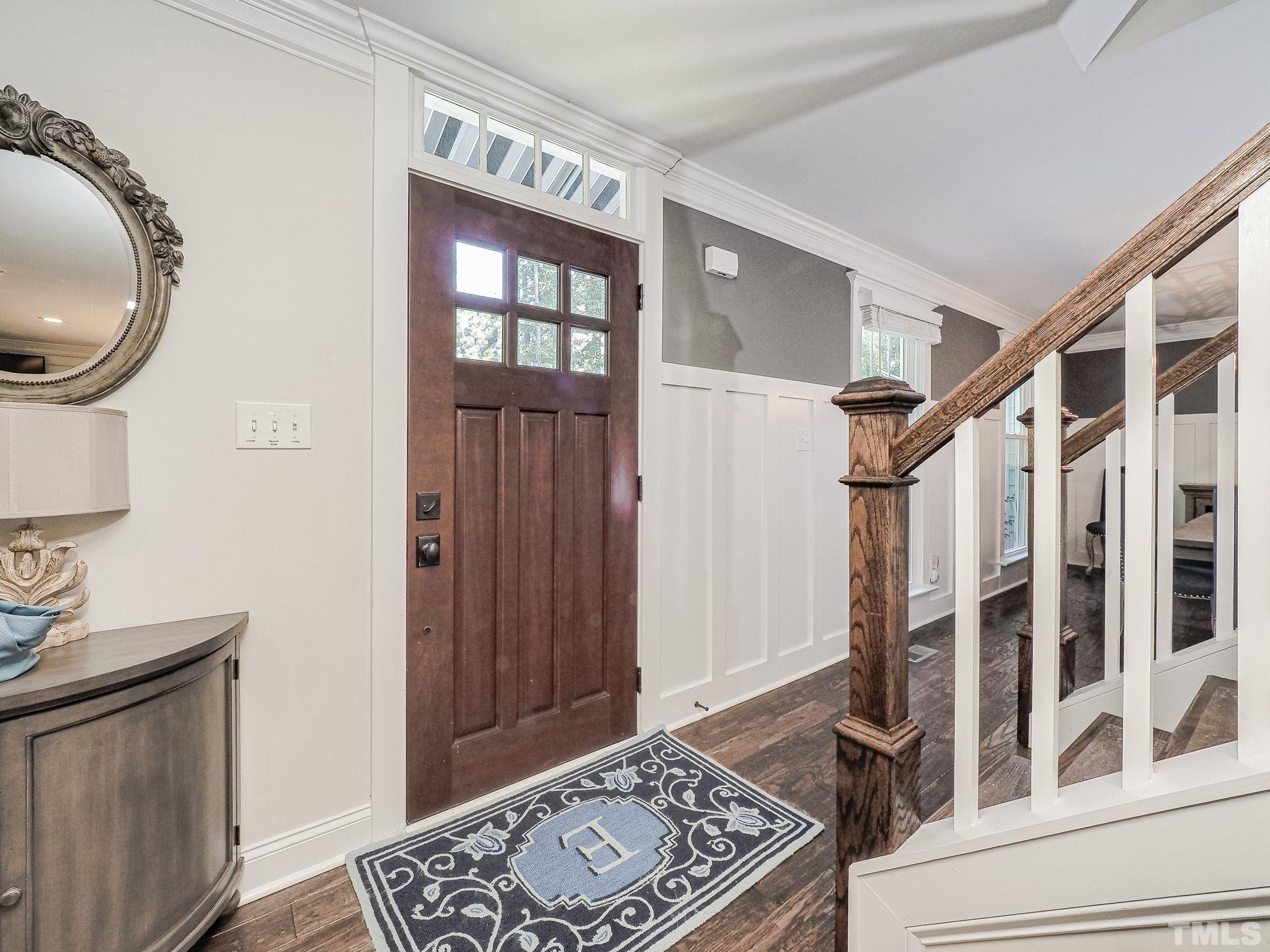 6908 Slade Hill Road Raleigh, NC 27615 - Photo 5 of 41 a view of an entryway with wooden floor and mirror