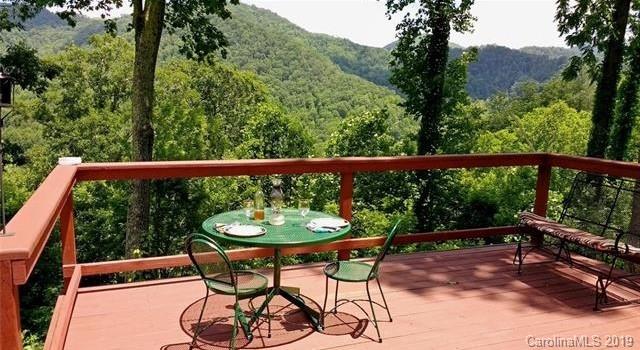 555 Short Ridge Lane Clyde, NC 28721 - Photo 1 of 21 a view of a chairs and table in the outdoor