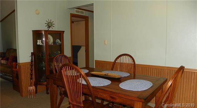 555 Short Ridge Lane Clyde, NC 28721 - Photo 14 of 21 a view of a dining room with furniture and wooden floor