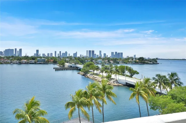 a living room with patio furniture and a large window