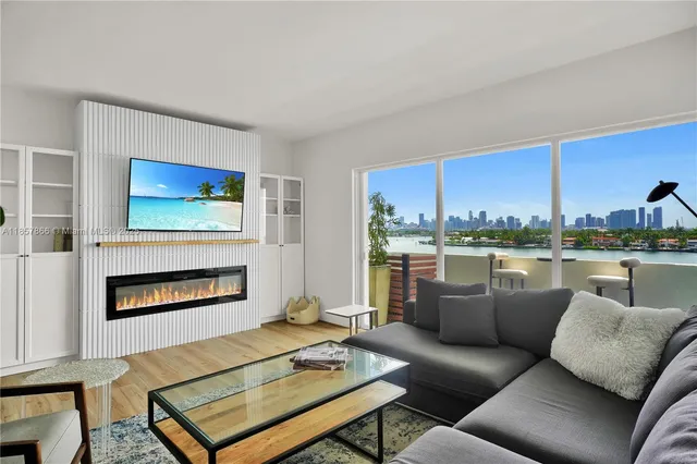 a living room with furniture a rug and a fireplace