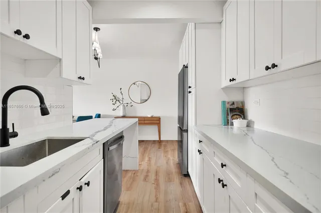 a kitchen with cabinets a sink and appliances