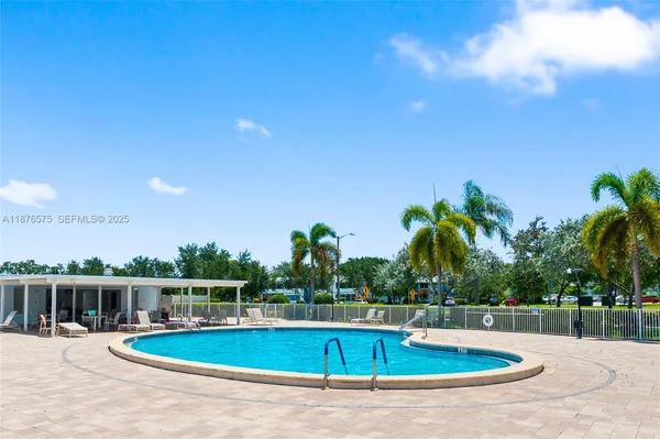 a view of a swimming pool with an outdoor seating