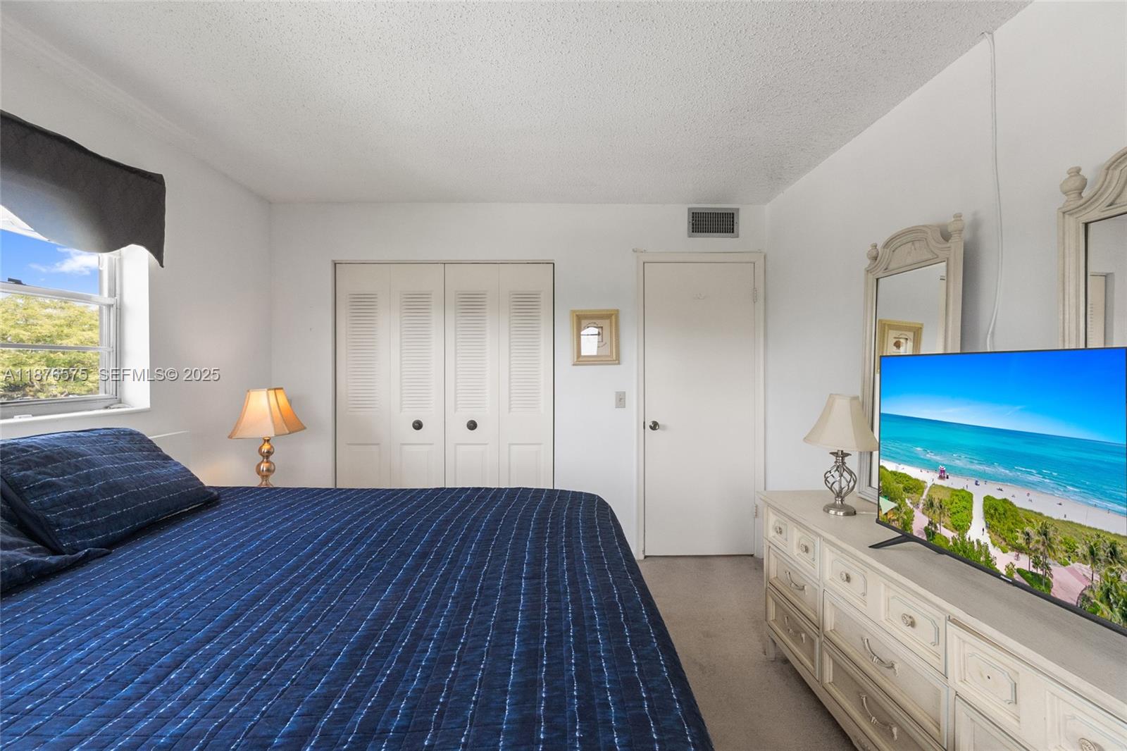 431 Markham South, Unit 431 Deerfield Beach, FL 33442 - Photo 12 of 30 a bedroom with a bed and a potted plant on dresser