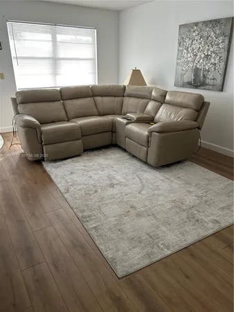 a living room with couches and a window