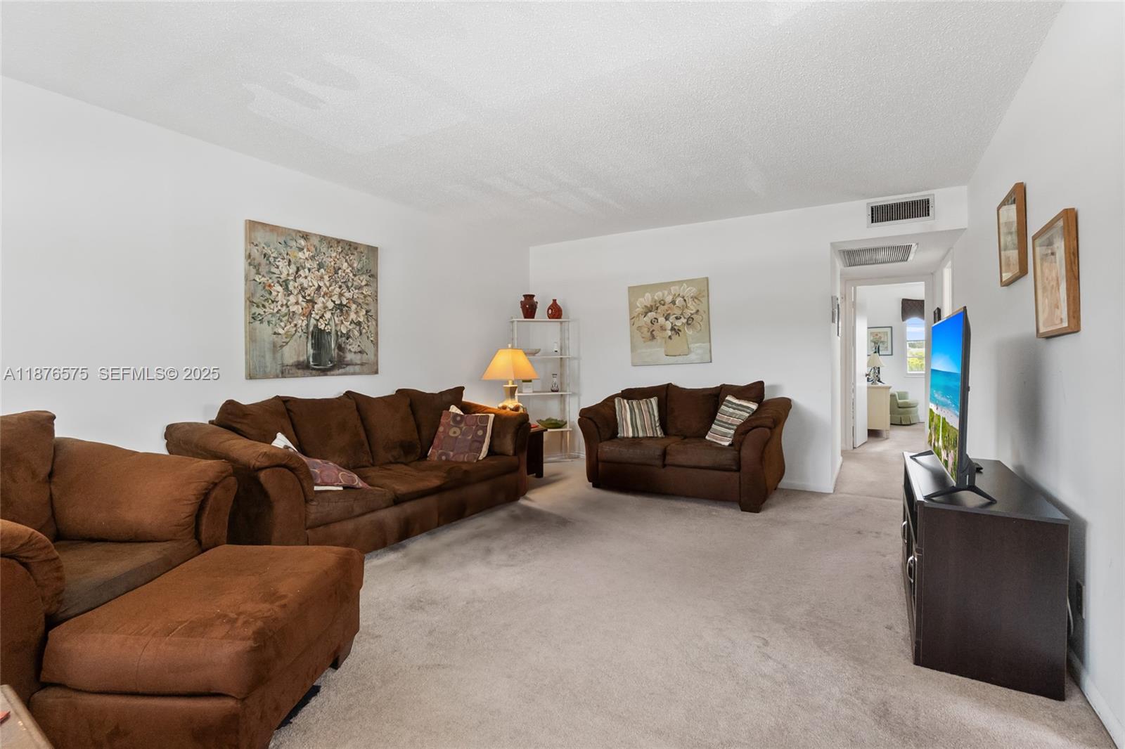 431 Markham South, Unit 431 Deerfield Beach, FL 33442 - Photo 18 of 30 a living room with furniture and a flat screen tv