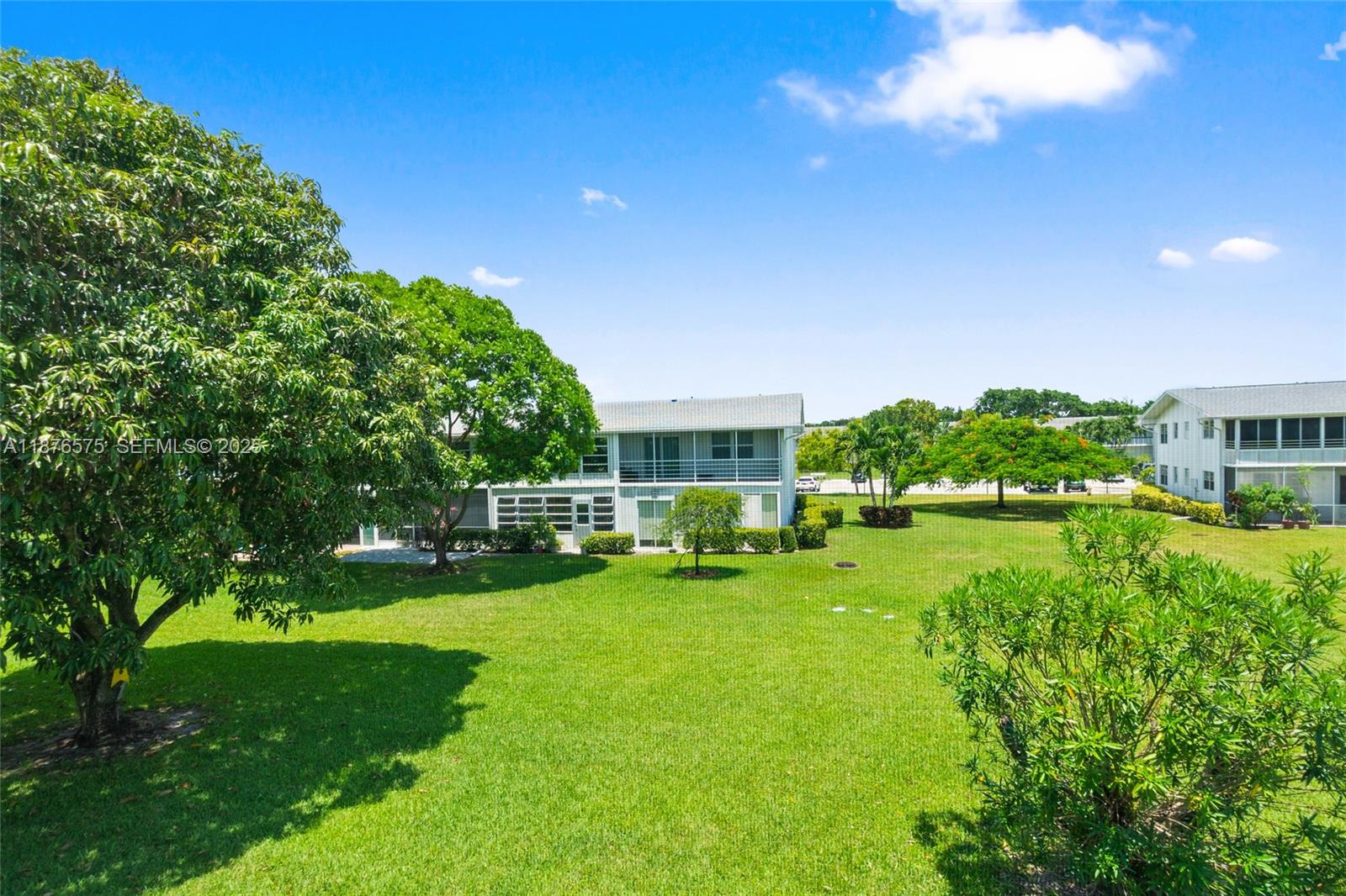 431 Markham South, Unit 431 Deerfield Beach, FL 33442 - Photo 19 of 30 a view of a house with a big yard