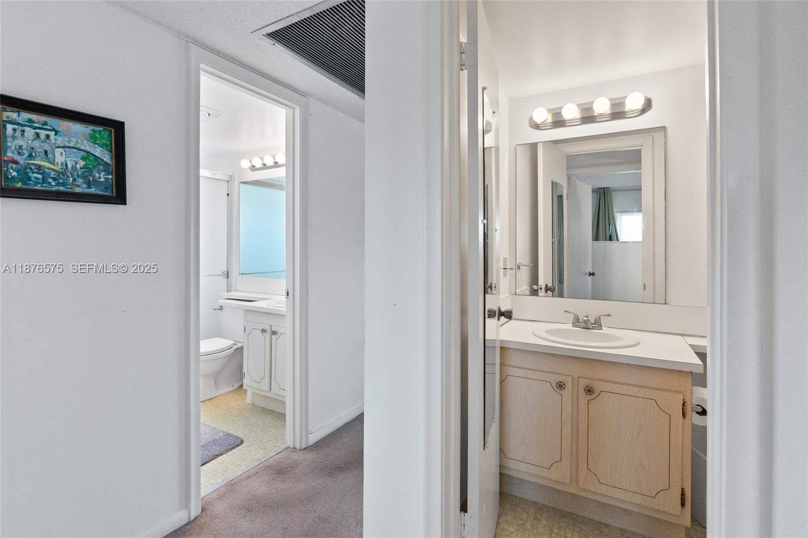 431 Markham South, Unit 431 Deerfield Beach, FL 33442 - Photo 25 of 30 a bathroom with a sink and a mirror