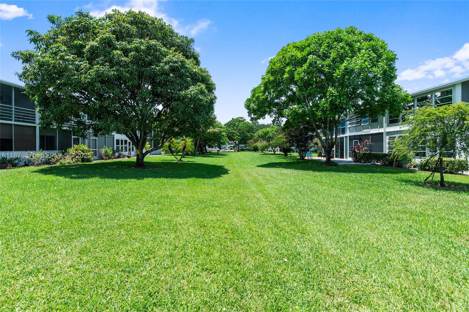 431 Markham South, Unit 431 Deerfield Beach, FL 33442 - Photo 27 of 30 a view of a house with a big yard