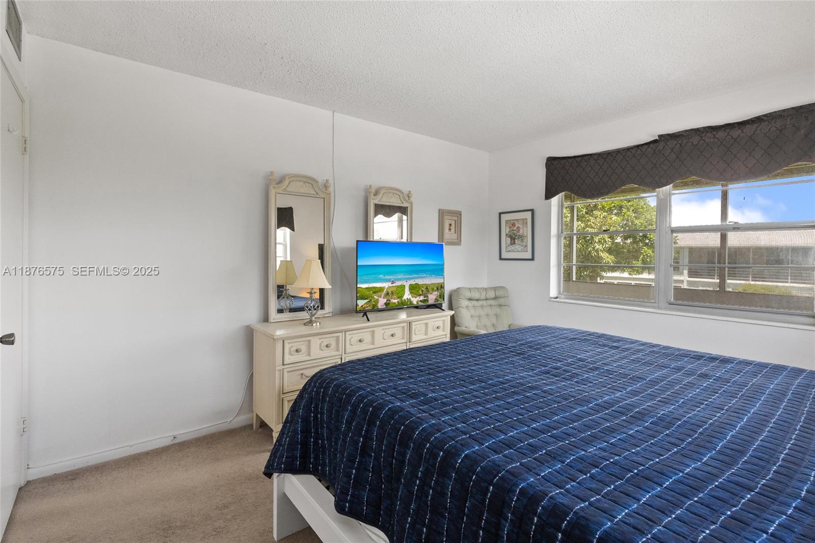 431 Markham South, Unit 431 Deerfield Beach, FL 33442 - Photo 28 of 30 a bedroom with a bed and a large window