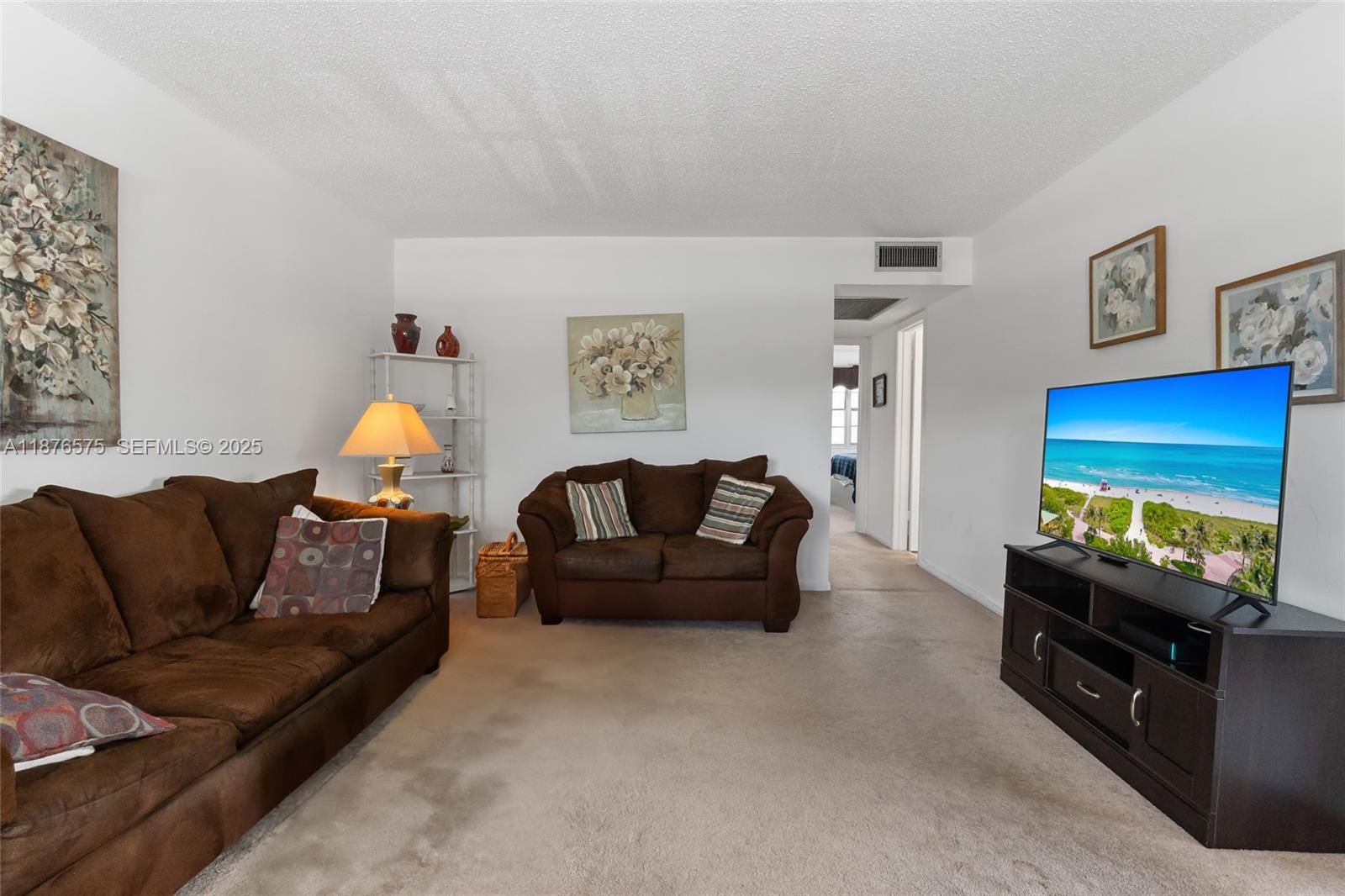 431 Markham South, Unit 431 Deerfield Beach, FL 33442 - Photo 3 of 30 a living room with furniture and a flat screen tv
