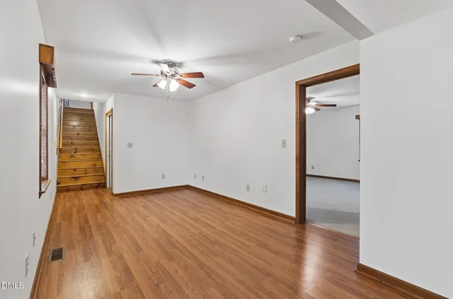 a spacious bathroom with a toilet sink and mirror