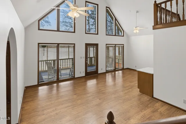 an empty room with closet and fan